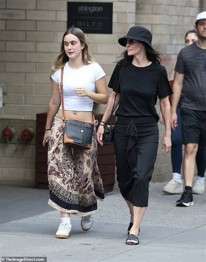 Mama bear: The Scream star paired the dress with a black straw hat, black slides and a small black handbag