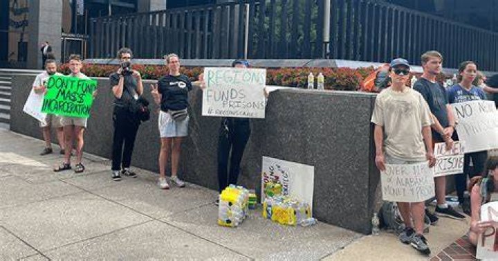 Protesters rally outside of Regions Center in Birmingham, decry prison